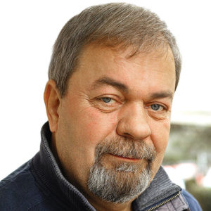 A man smiles at the camera.