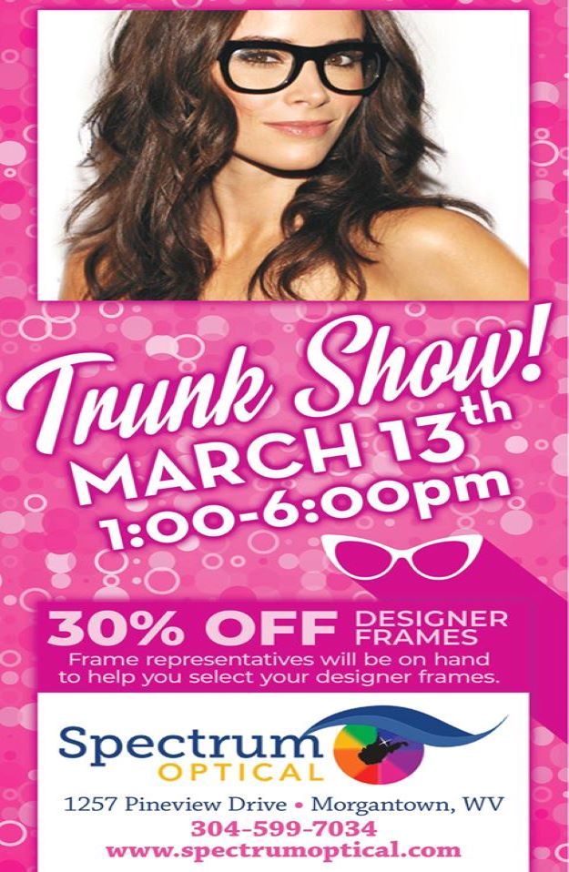 A woman wearing simple black frames smiles above an ad for the 2020 Trunk Show.