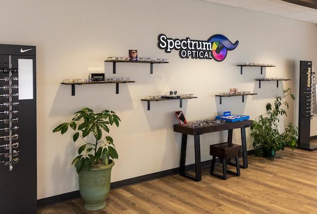 Spectrum Office Interior: Shelves are filled with designer frames amidst the Spectrum Optical logo.