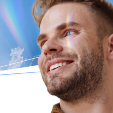 A man smiles while sunlight shines on his face. Dry eye relief is available now!